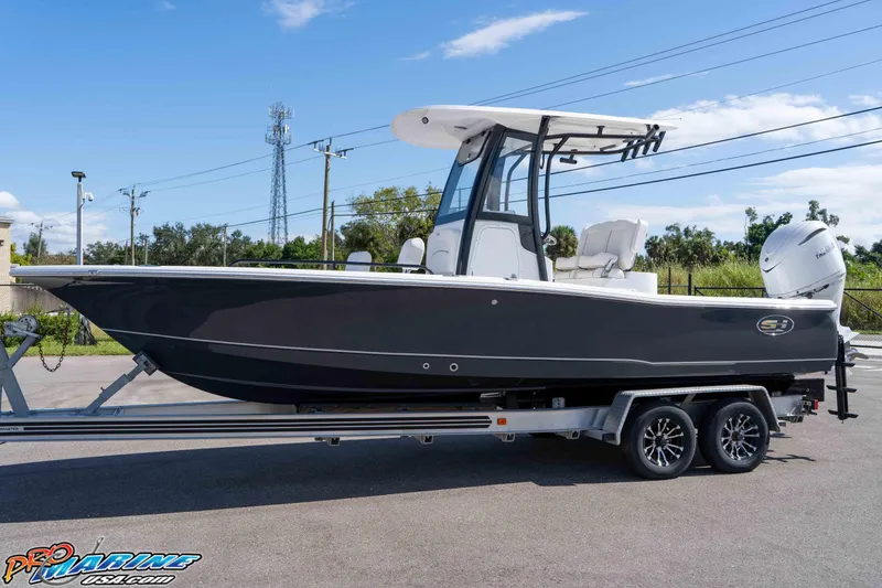 Slide: The Image of 2026 Sea Hunt BX 25 FS boat on trailer, parked outdoors under clear sky. - 7