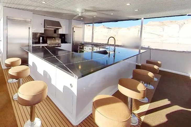 Slide: The Image of Luxurious kitchen area on 2022 Adonia Splendor yacht with modern appliances and bar seating. - 25