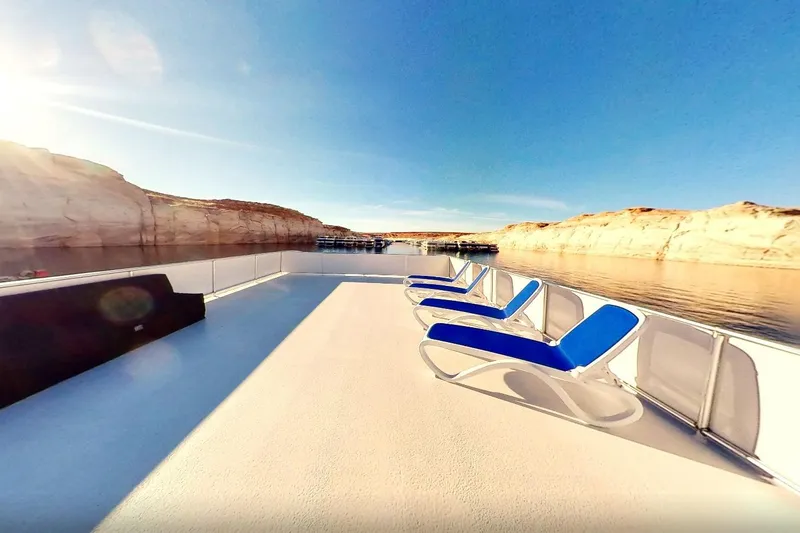 Slide: The Image of Sunlit deck of 2022 Adonia Splendor with blue loungers, scenic canyon view. - 35