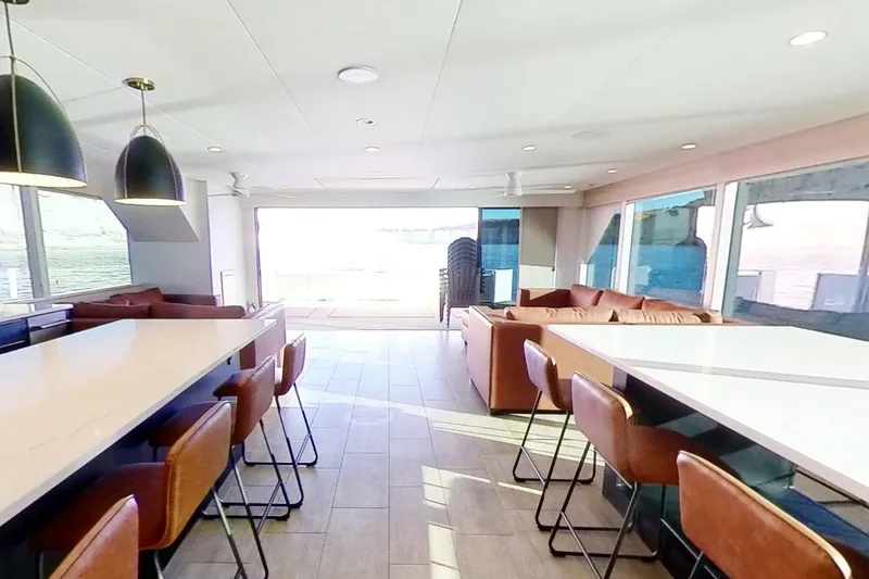 Slide: The Image of Luxurious interior of 2022 Adonia Splendor yacht with modern seating and large windows. - 5