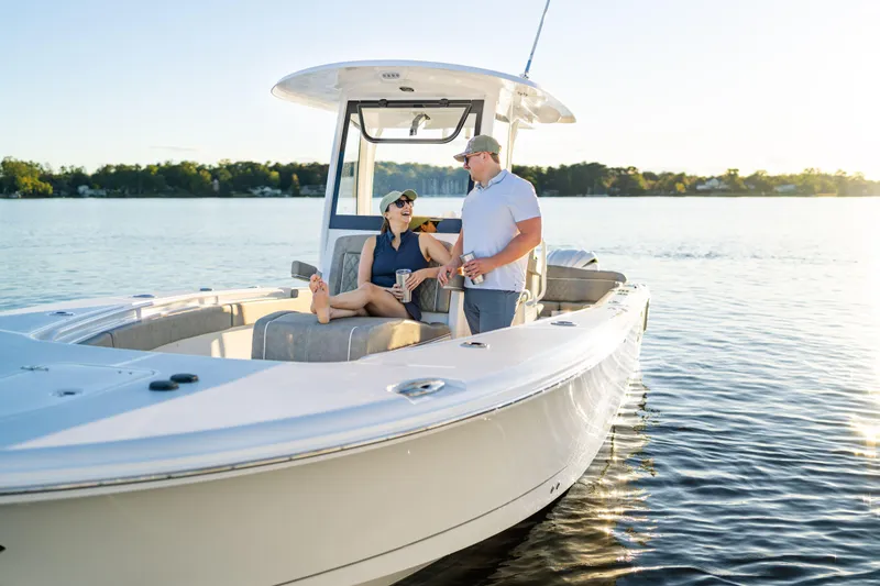 Slide: The Image of Couple enjoying a sunny day on a 2026 Sea Hunt Ultra 275 Coffin Box boat. - 14
