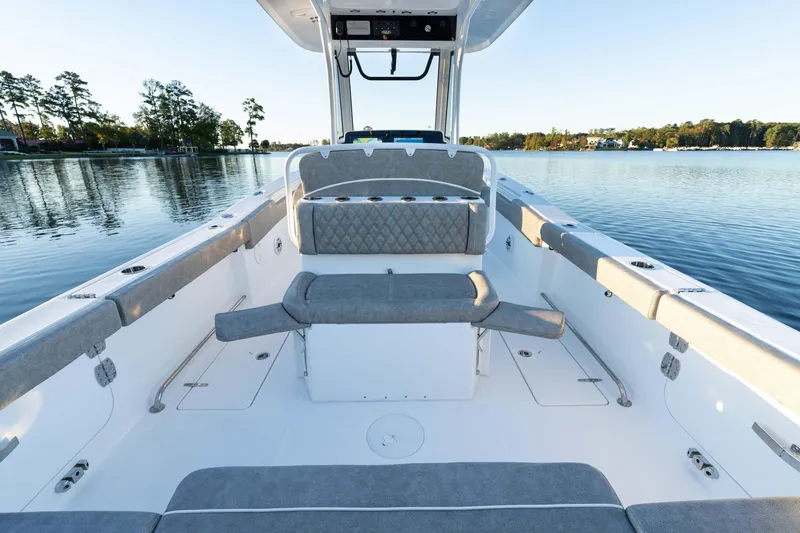 Slide: The Image of 2026 Sea Hunt Ultra 275 Coffin Box boat interior on a serene lake. - 25