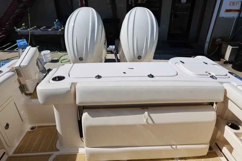 Slide: The Image of 2025 Grady-White Freedom 275 boat with dual engines and sleek white seating. - 10