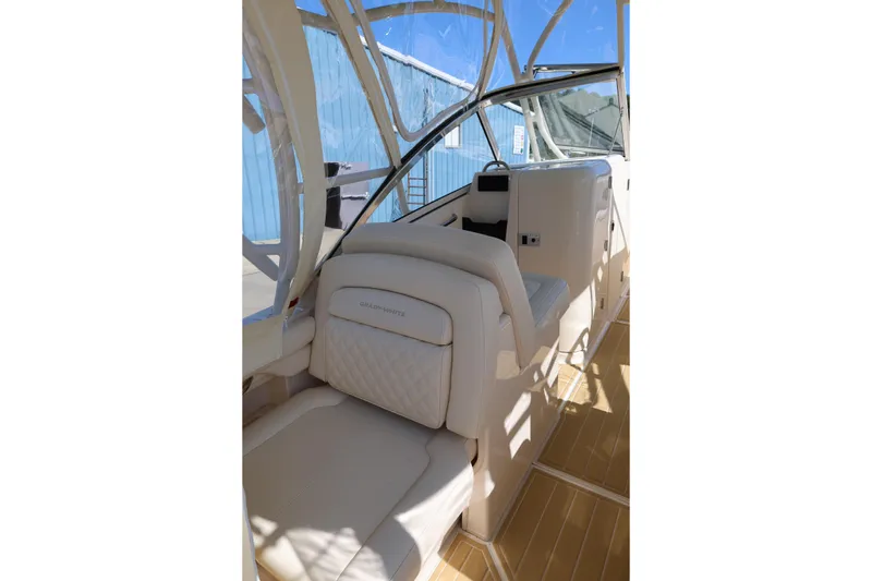 Slide: The Image of 2025 Grady-White Freedom 275 boat interior with white seating and helm station. - 11