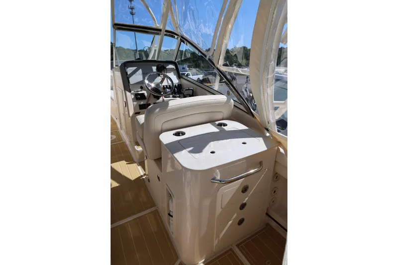 Slide: The Image of 2025 Grady-White Freedom 275 boat interior with steering wheel and seating. - 12