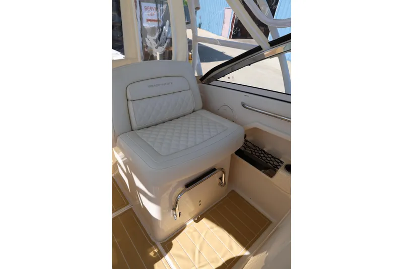 Slide: The Image of 2025 Grady-White Freedom 275 boat interior with cushioned seating and storage. - 14