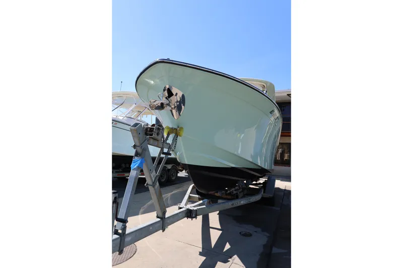 Slide: The Image of 2025 Grady-White Freedom 275 boat on trailer, viewed from the front. - 2