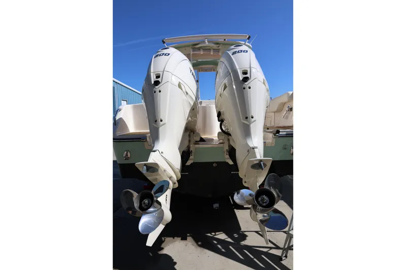 Slide: The Image of 2025 Grady-White Freedom 275 boat with dual outboard engines, rear view. - 3