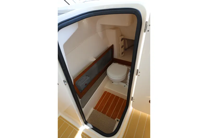 Slide: The Image of 2025 Grady-White Freedom 275 boat interior with compact marine toilet. - 4