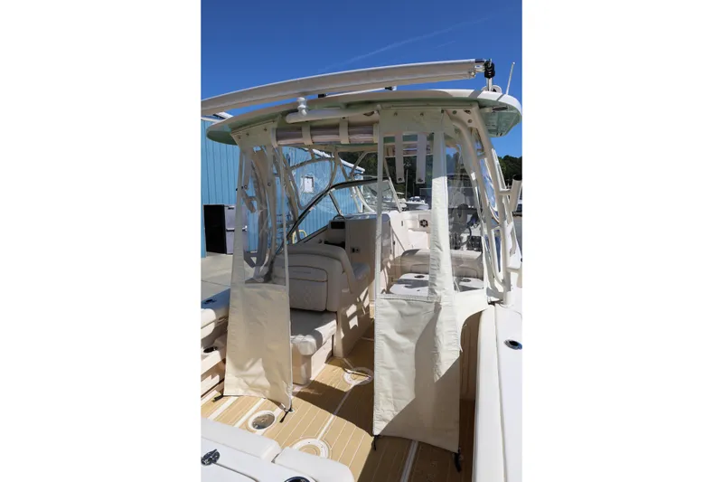 Slide: The Image of 2025 Grady-White Freedom 275 boat interior with protective canopy and seating. - 8
