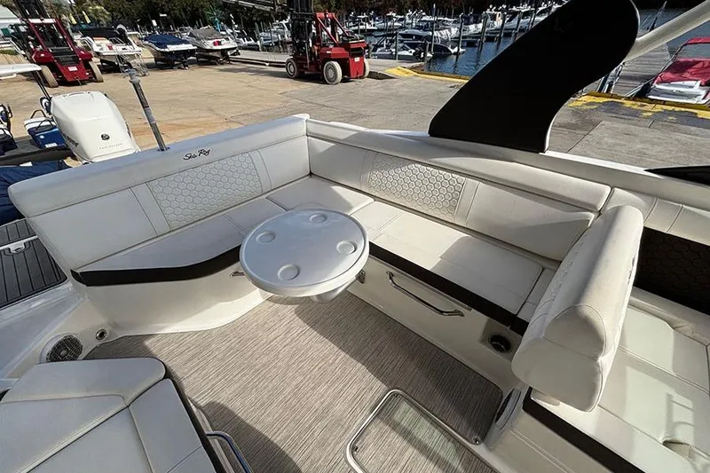 Slide: The Image of 2018 Sea Ray SDX 270 Outboard boat interior with white seating and round table. - 12