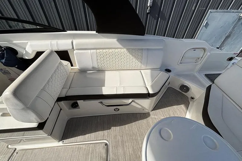 Slide: The Image of 2018 Sea Ray SDX 270 Outboard interior with white seating and modern design. - 13