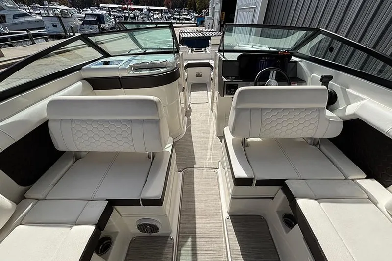 Slide: The Image of 2018 Sea Ray SDX 270 Outboard interior with white seating and modern dashboard. - 16