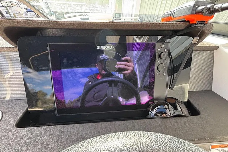 Slide: The Image of Simrad display on 2018 Sea Ray SDX 270 Outboard dashboard with remote control. - 19