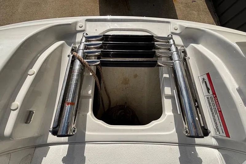 Slide: The Image of 2018 Sea Ray SDX 270 Outboard boat ladder, stainless steel, folded, with safety warning label. - 21