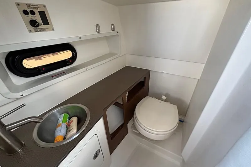 Slide: The Image of 2018 Sea Ray SDX 270 Outboard boat bathroom with sink and toilet. - 26