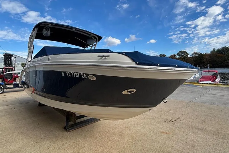 Slide: The Image of 2018 Sea Ray SDX 270 Outboard boat on a dock under a blue sky. - 5