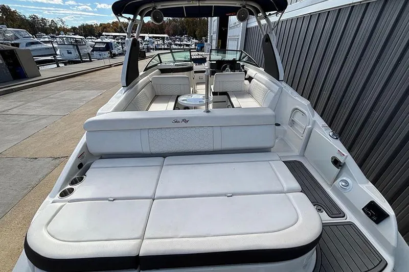 Slide: The Image of 2018 Sea Ray SDX 270 Outboard boat with spacious seating at a marina. - 8