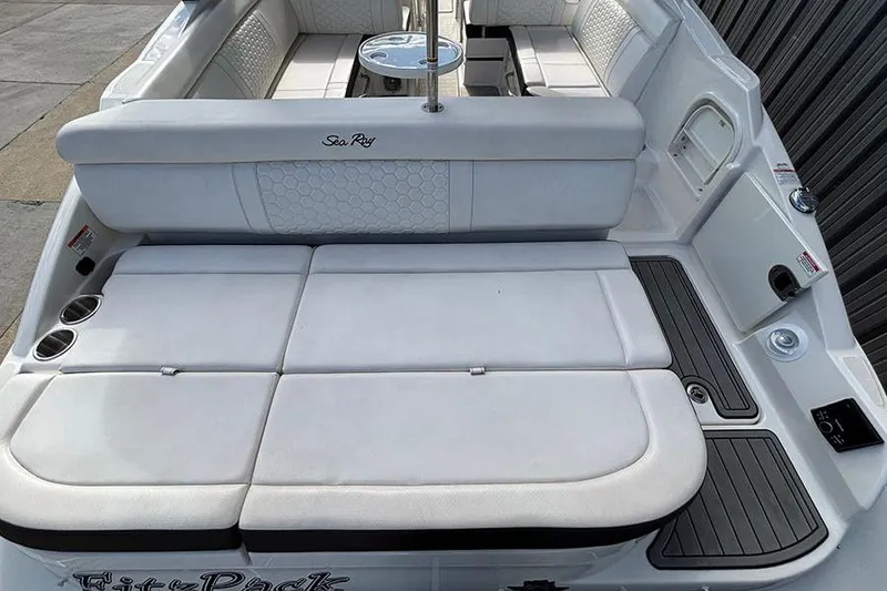 Slide: The Image of 2018 Sea Ray SDX 270 Outboard boat interior with white seating and cup holders. - 9