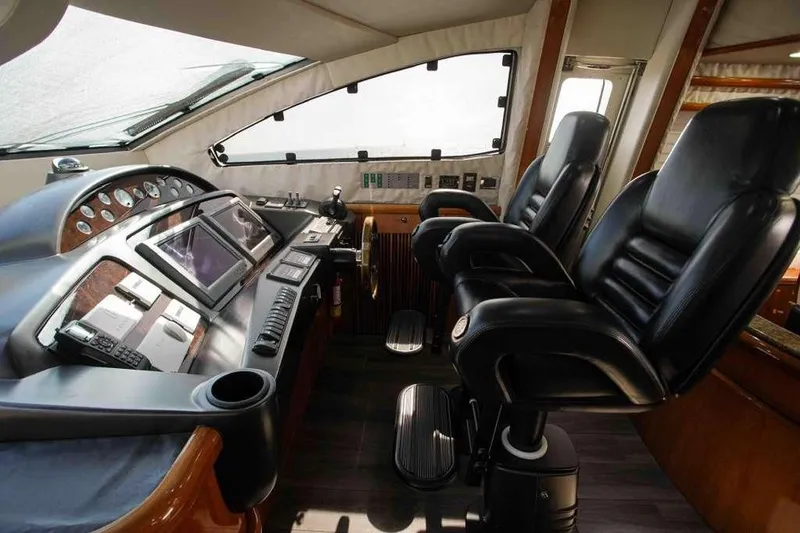 Slide: The Image of Luxurious cockpit of 2006 Sunseeker Manhattan Motor 82 yacht with leather seats and advanced controls. - 17
