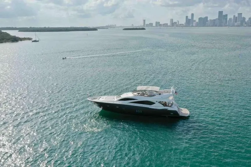 Slide: The Image of Luxury Sunseeker Manhattan Motor 82 yacht cruising near city skyline, 2006 model. - 2