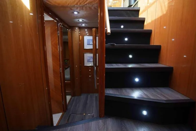 Slide: The Image of Luxurious interior staircase of 2006 Sunseeker Manhattan Motor 82 yacht with wood paneling and LED lights. - 25