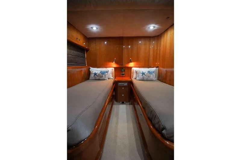 Slide: The Image of Luxurious twin cabin in 2006 Sunseeker Manhattan Motor 82 yacht, featuring elegant wood paneling. - 28