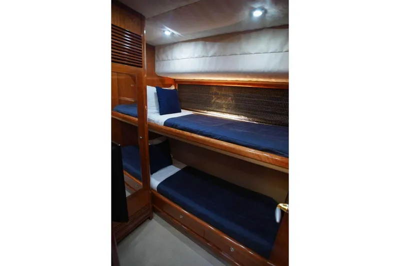 Slide: The Image of Bunk beds in 2006 Sunseeker Manhattan Motor 82 yacht cabin with blue bedding. - 31