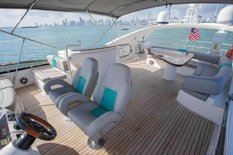 Slide: The Image of Luxurious 2006 Sunseeker Manhattan Motor 82 yacht deck with seating, ocean view, and city skyline. - 35