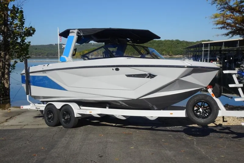 The Image of 2024 Nautique Super Air Nautique G23 boat on trailer by lakeside. - 0