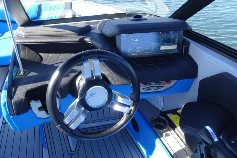 Slide: The Image of 2024 Nautique Super Air Nautique G23 dashboard with steering wheel and digital display. - 21