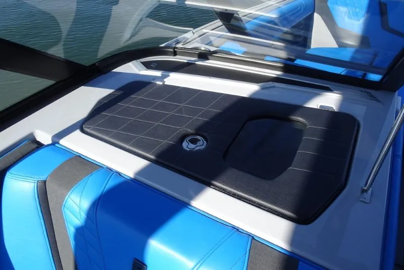 Slide: The Image of 2024 Nautique Super Air Nautique G23 interior with blue and black seating. - 27