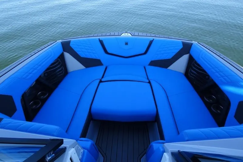 Slide: The Image of 2024 Nautique Super Air Nautique G23 boat interior with blue seating on water. - 30