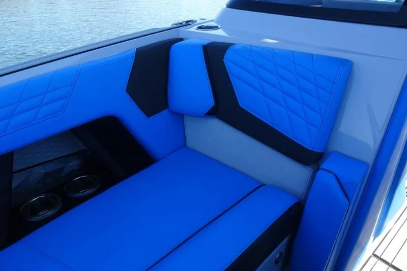 Slide: The Image of 2024 Nautique Super Air Nautique G23 interior with blue and black seating. - 32