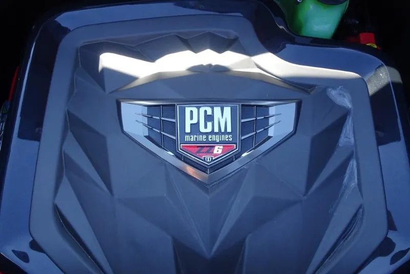 Slide: The Image of 2024 Nautique Super Air Nautique G23 engine cover with PCM marine engines logo. - 34