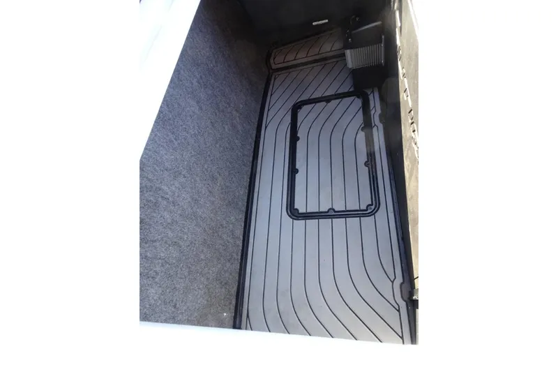 Slide: The Image of 2024 Nautique Super Air Nautique G23 storage compartment with sleek, lined flooring. - 35