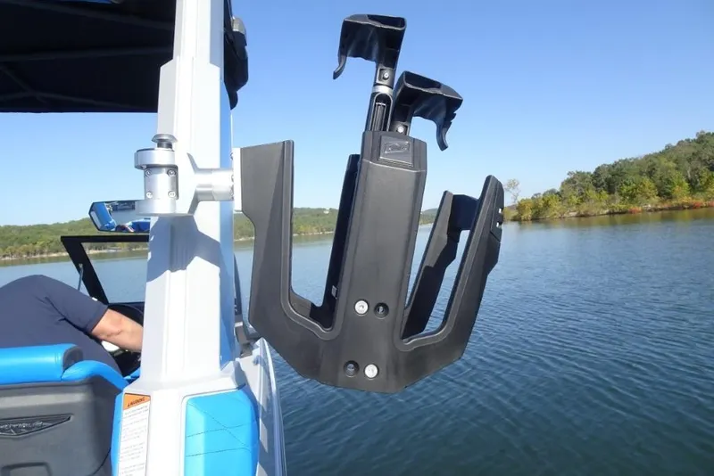 Slide: The Image of 2024 Nautique Super Air Nautique G23 wakeboard rack on a serene lake. - 38
