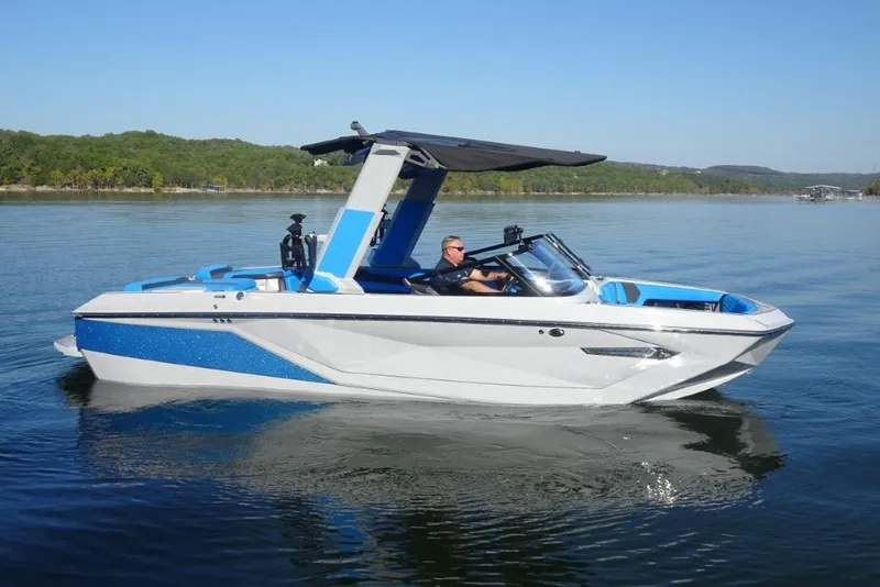 Slide: The Image of 2024 Nautique Super Air Nautique G23 boat cruising on a calm lake. - 8