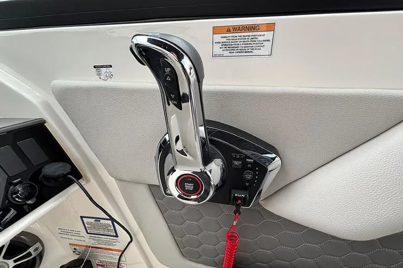Slide: The Image of 2023 Sea Ray SDX 270 Outboard throttle control with start/stop button and warning label. - 14