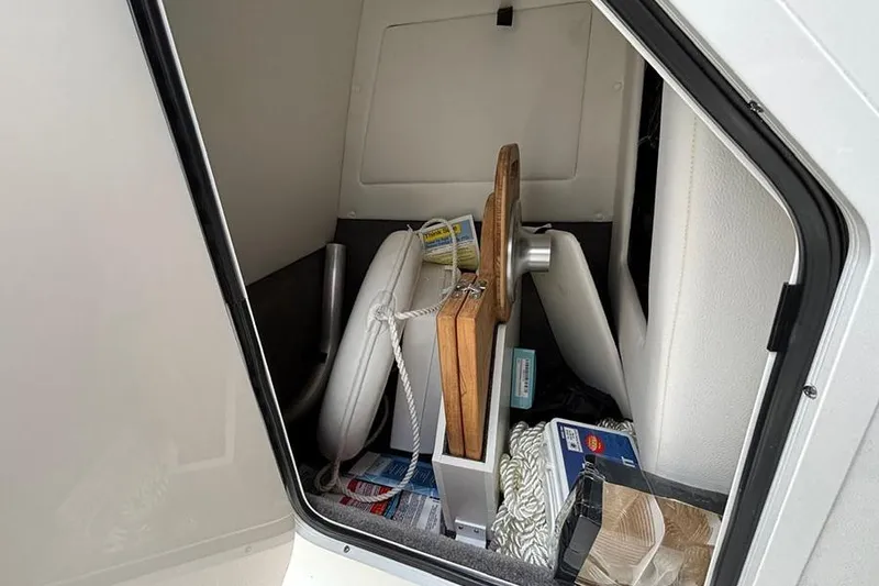 Slide: The Image of Storage compartment of 2023 Sea Ray SDX 270 Outboard with various boating accessories. - 18