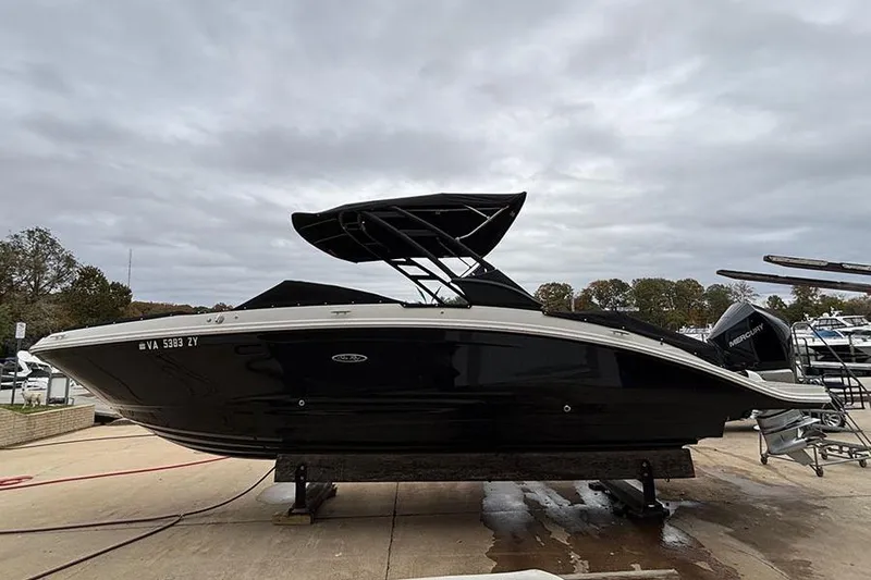 Slide: The Image of 2023 Sea Ray SDX 270 Outboard boat on a dock under cloudy skies. - 2
