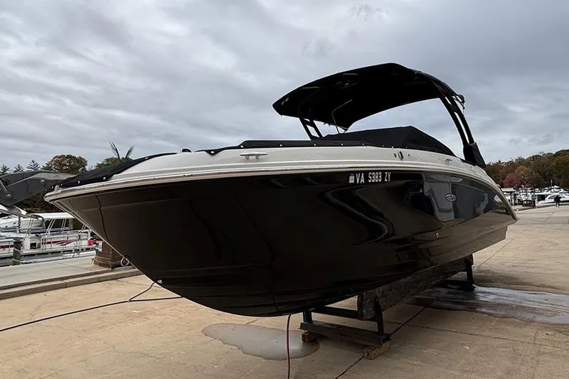 Slide: The Image of 2023 Sea Ray SDX 270 Outboard boat on a dock under cloudy skies. - 4