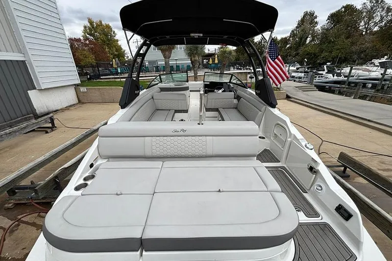 Slide: The Image of 2023 Sea Ray SDX 270 Outboard boat with spacious seating and sleek design at a marina. - 6