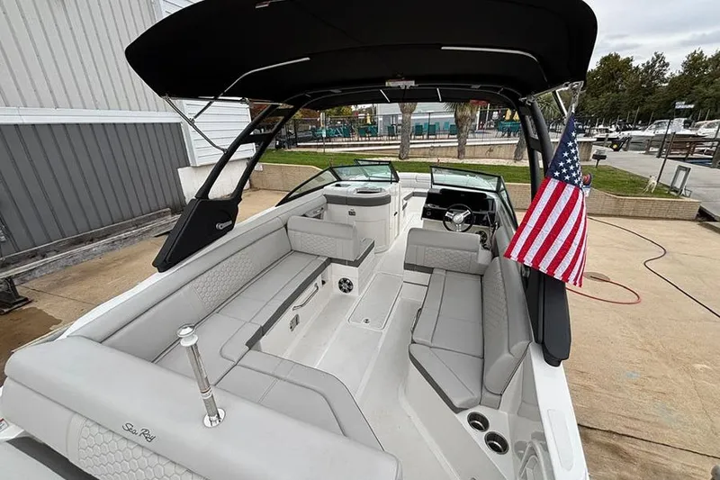 Slide: The Image of 2023 Sea Ray SDX 270 Outboard boat interior with seating and American flag. - 8
