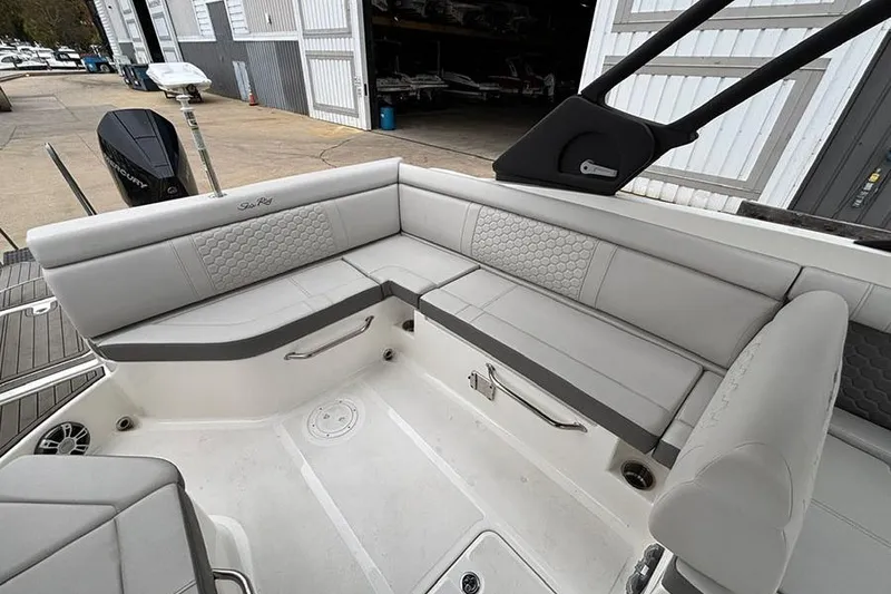 Slide: The Image of 2023 Sea Ray SDX 270 Outboard boat interior with gray seating and storage compartments. - 9