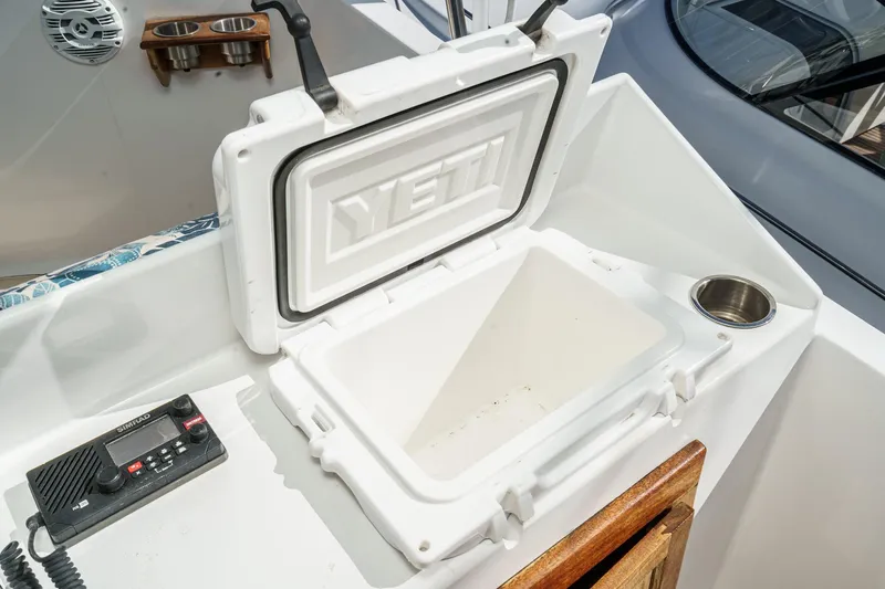 Slide: The Image of 1974 Hatteras Convertible Sportfisher with open YETI cooler and marine radio. - 19