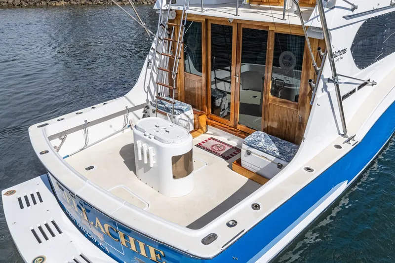 Slide: The Image of 1974 Hatteras Convertible Sportfisher boat with spacious deck and wooden doors. - 23