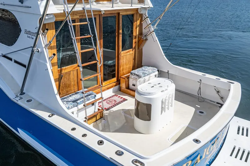 Slide: The Image of 1974 Hatteras Convertible Sportfisher boat with wooden accents and fishing equipment. - 26