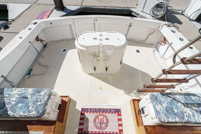 Slide: The Image of 1974 Hatteras Convertible Sportfisher boat deck with floral cushions and welcome mat. - 27