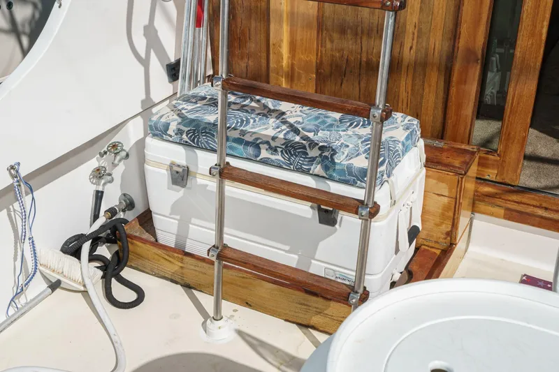 Slide: The Image of 1974 Hatteras Convertible Sportfisher deck with cushioned cooler and wooden ladder. - 29